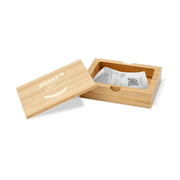 A bamboo bill box with a lid, partially open, displaying a white card with the brand 'Bistro' printed on it, and containing some colorful buttons or candies.