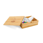 A bamboo bill box with a lid, partially open, displaying a white card with the brand 'Bistro' printed on it, and containing some colorful buttons or candies.