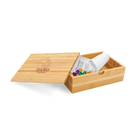 A bamboo bill box with a lid, partially open, displaying a white card with the brand 'Bistro' printed on it, and containing some colorful buttons or candies.