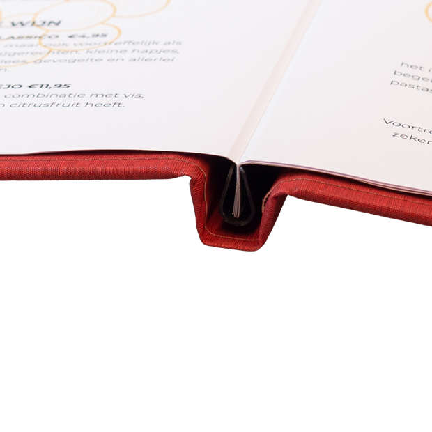 A close-up of a menu in a clamp spine of a red cover 