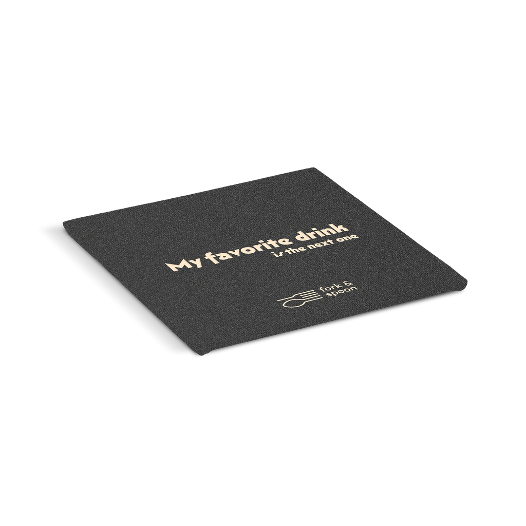 Black coaster with text 'My favorite drink is the next one' on a white background