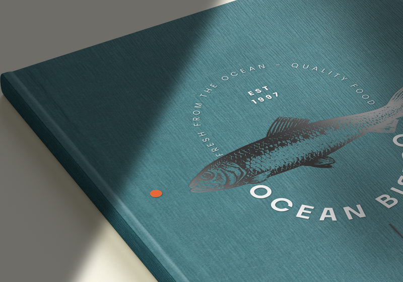 A close-up of a green cover with a ocean bistro logo printed