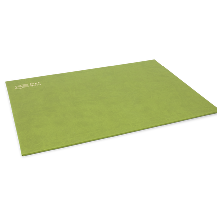 A green rectangular placemat made from vegan leather, with a subtle textured surface and visible stitching along the edges.