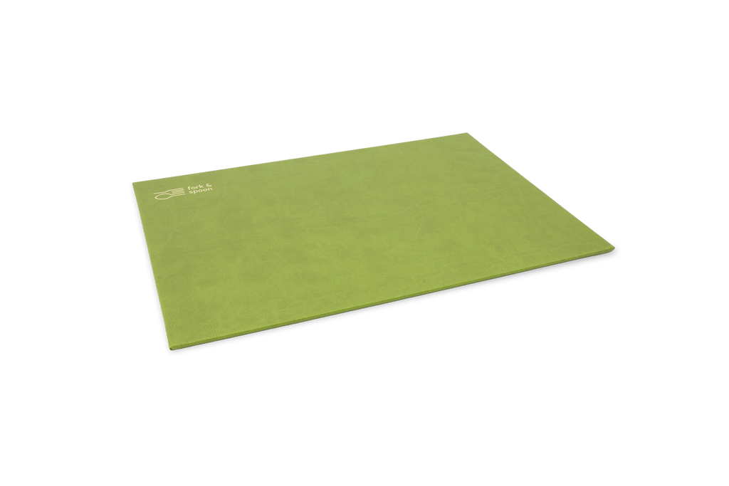 A green rectangular placemat made from vegan leather, with a subtle textured surface and visible stitching along the edges.