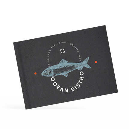 A classy clamp menu with a black cover featuring a white 'ocean bistro' logo.
