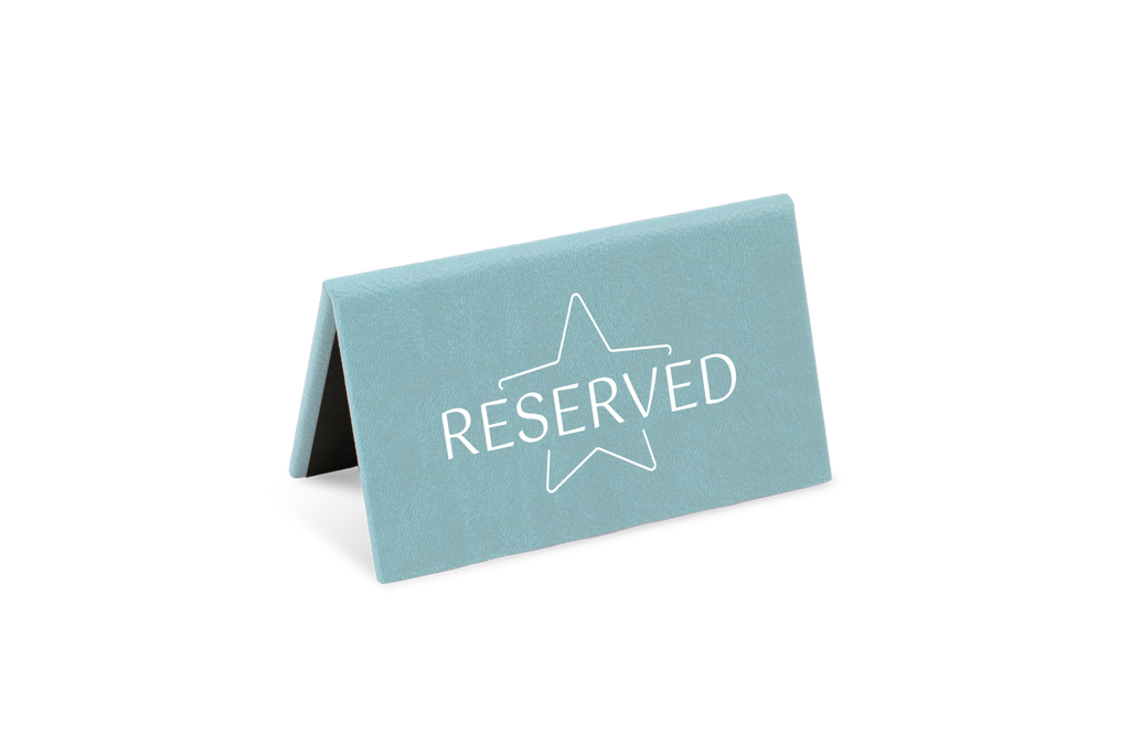 A blue reserved sign with a white star and the word 'RESERVED' printed on it.