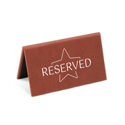 A brown reserved sign with a white star and the word 'RESERVED' printed on it.