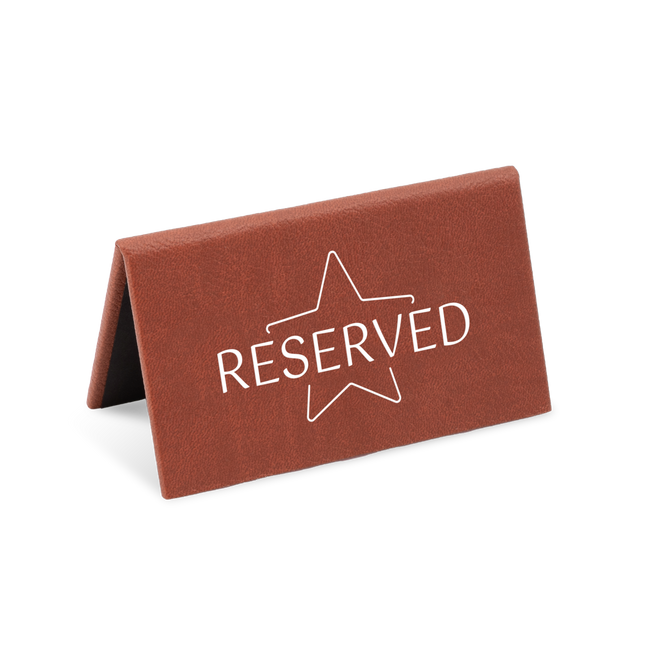 A brown reserved sign with a white star and the word 'RESERVED' printed on it.