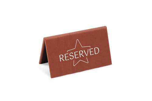 A brown reserved sign with a white star and the word 'RESERVED' printed on it.