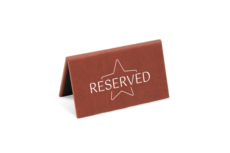 A brown reserved sign with a white star and the word 'RESERVED' printed on it.