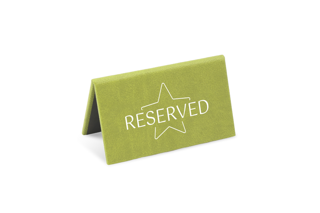 A green reserved sign with a white star and the word 'RESERVED' printed on it.