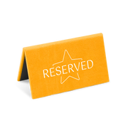 A orange reserved sign with a white star and the word 'RESERVED' printed on it.