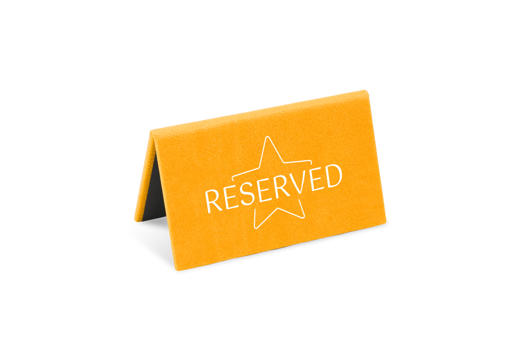 A orange reserved sign with a white star and the word 'RESERVED' printed on it.