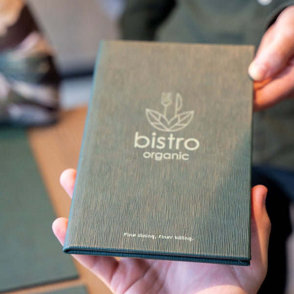 Person holding a green bill holder