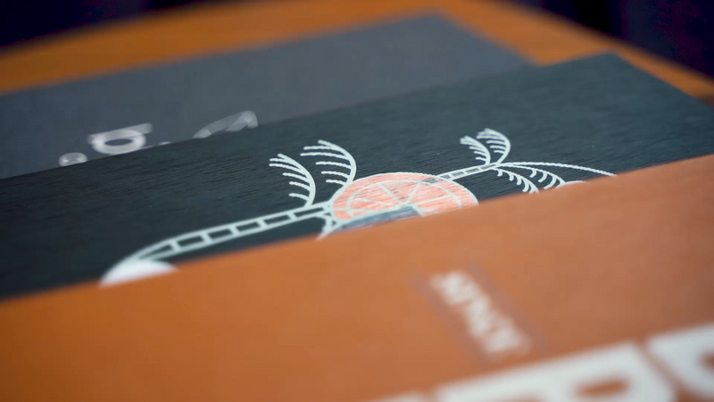 Close-up of hard cover menus in various colours and logos printed